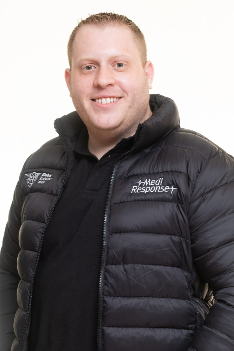 Medi Response medical emergency services team member in a branded black puffer jacket, smiling on a white studio background